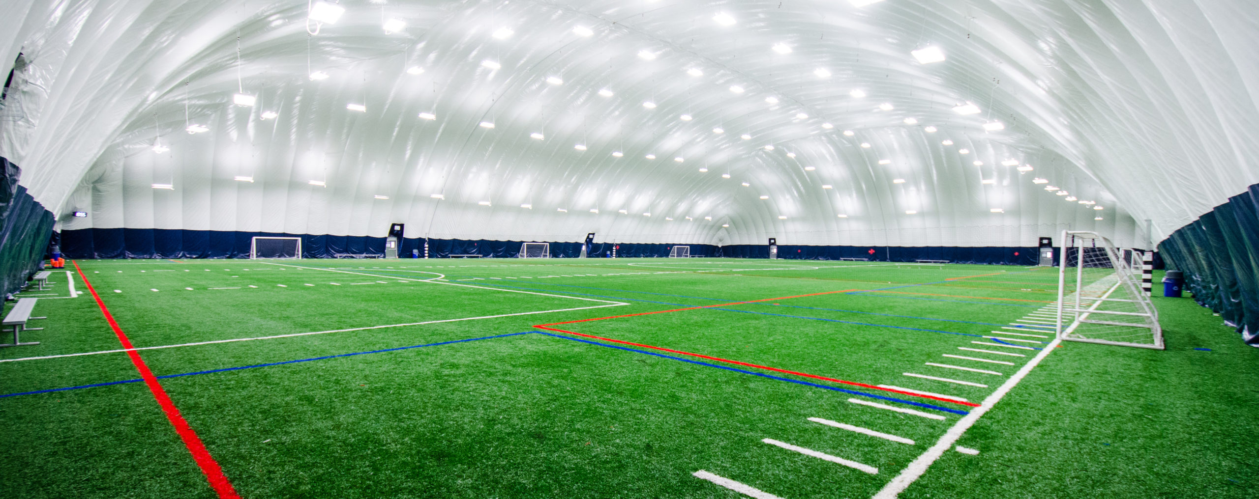 Wide angle shot of soccer field within air dome.