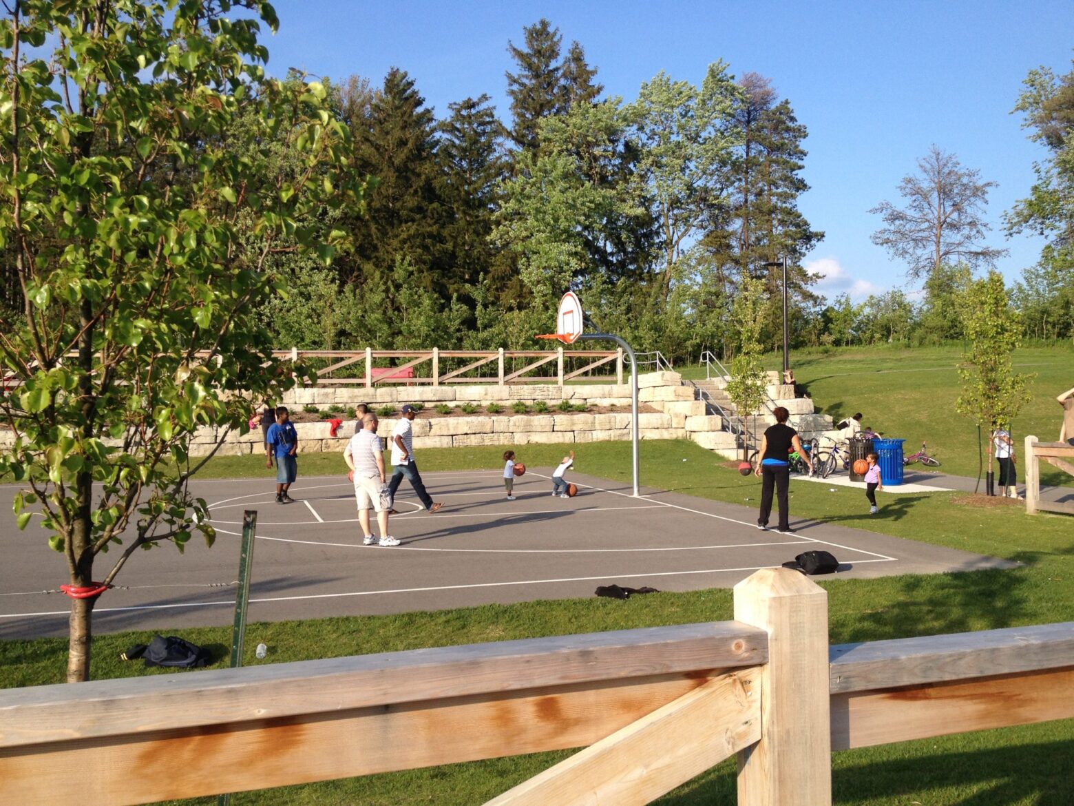 People playing basketball in a court.