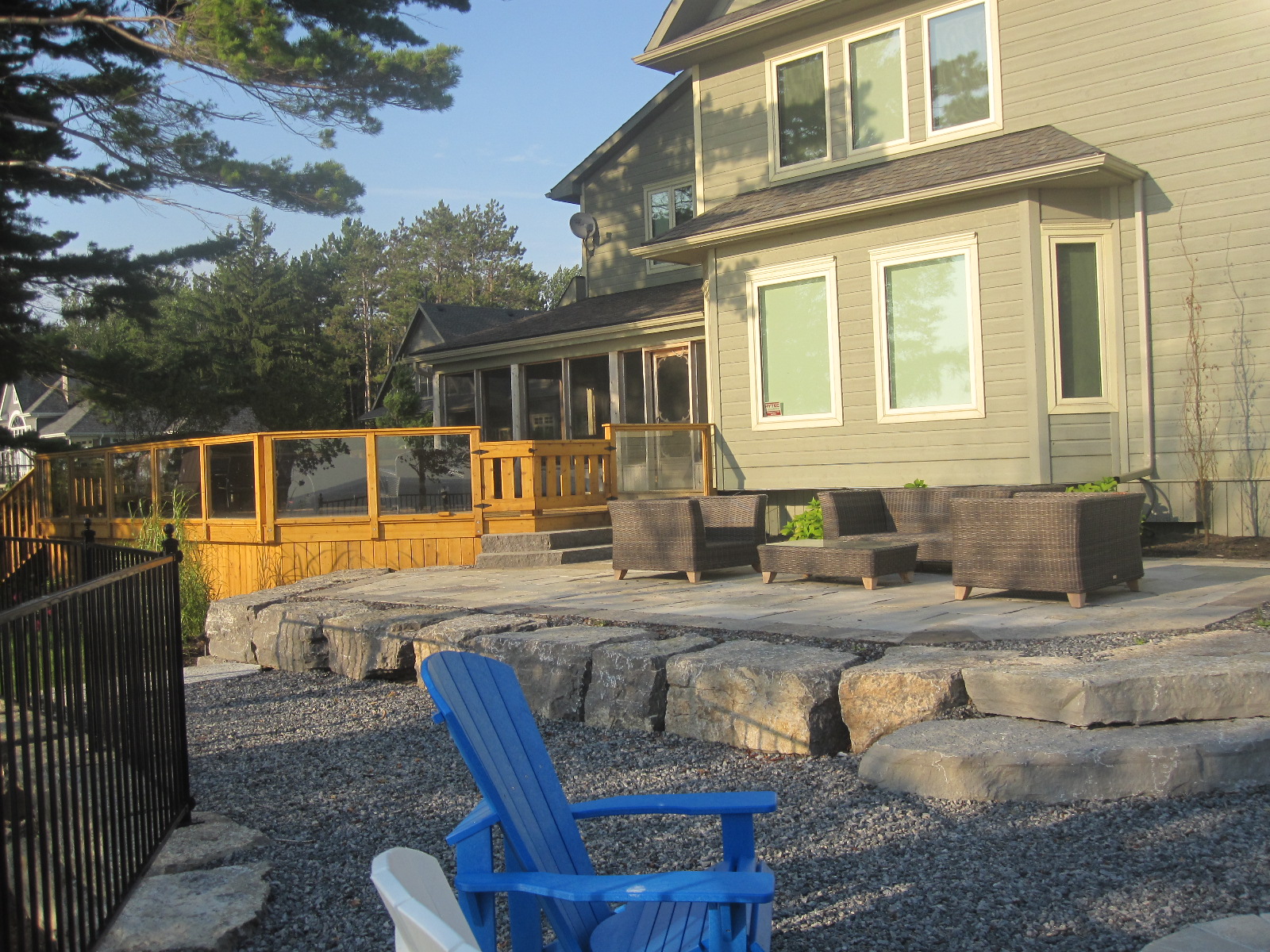 Back of cottage with large stones to sit on.