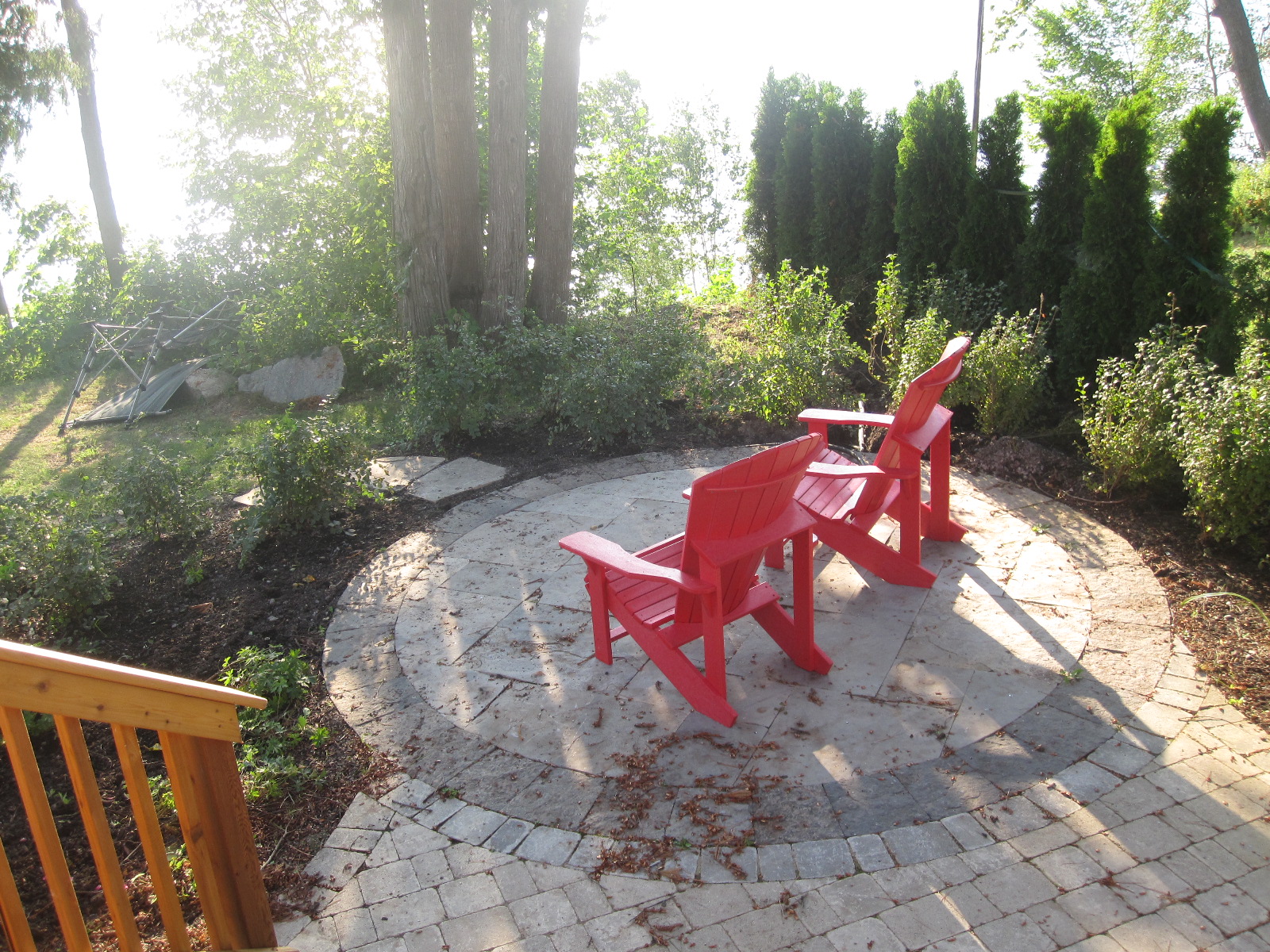 Two red adirondack chairs.