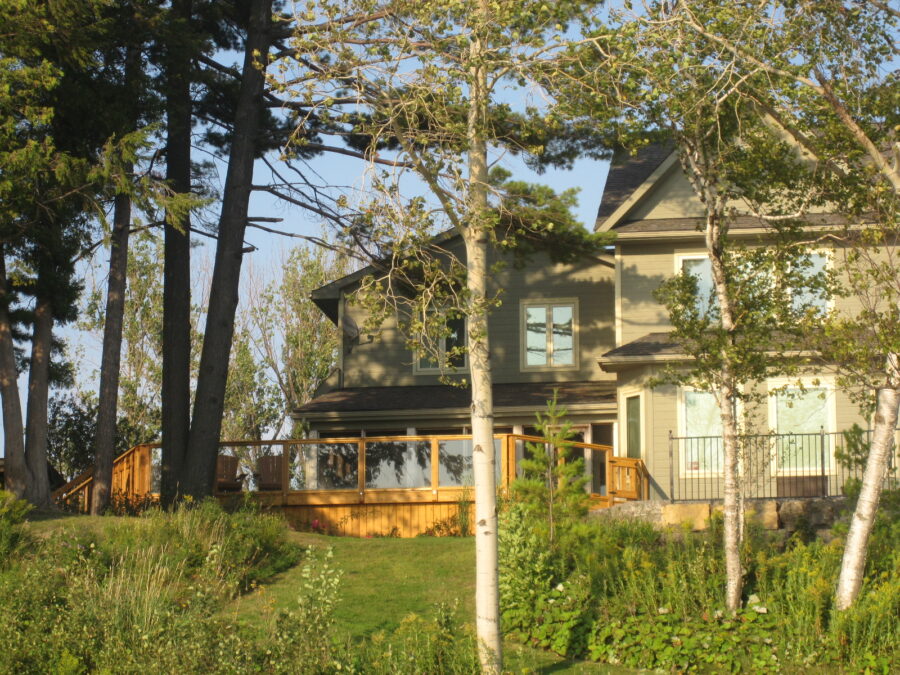 Back of cottage with large deck.