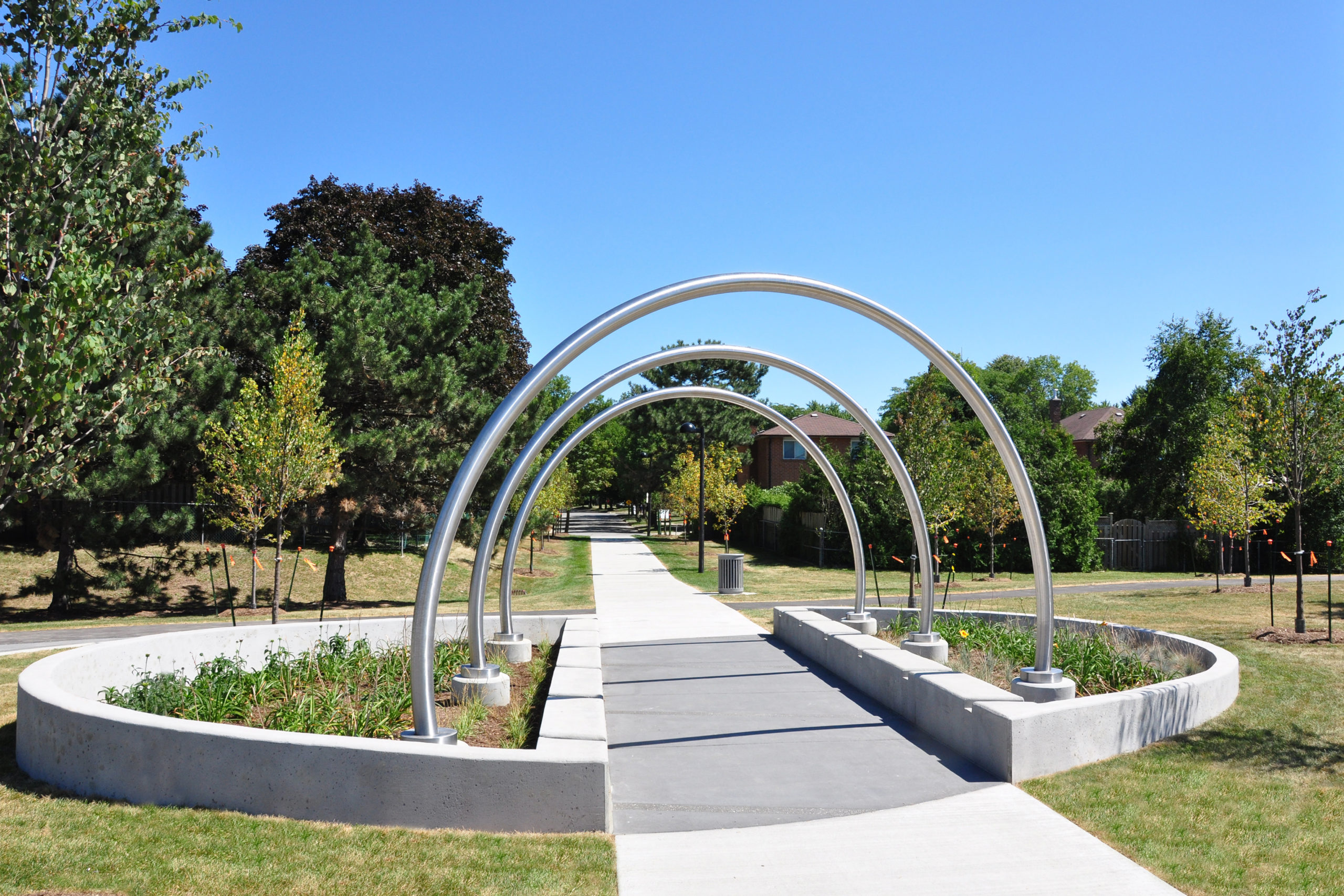 Pathway into park with metal loops.