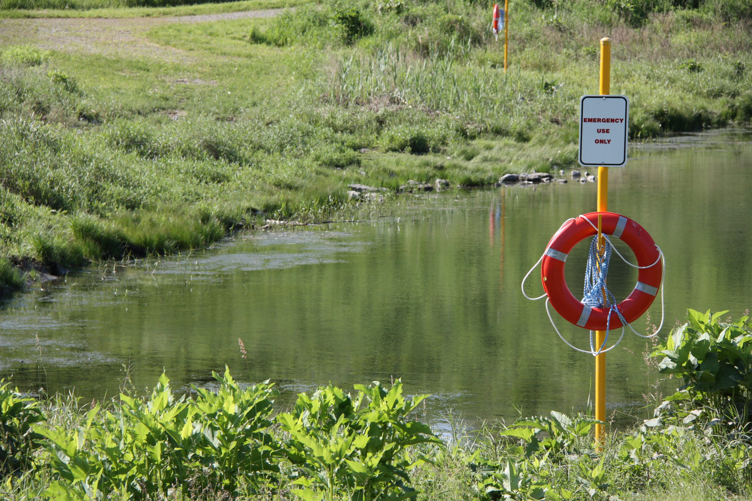 Pond with emergency equipment in case of drowning.