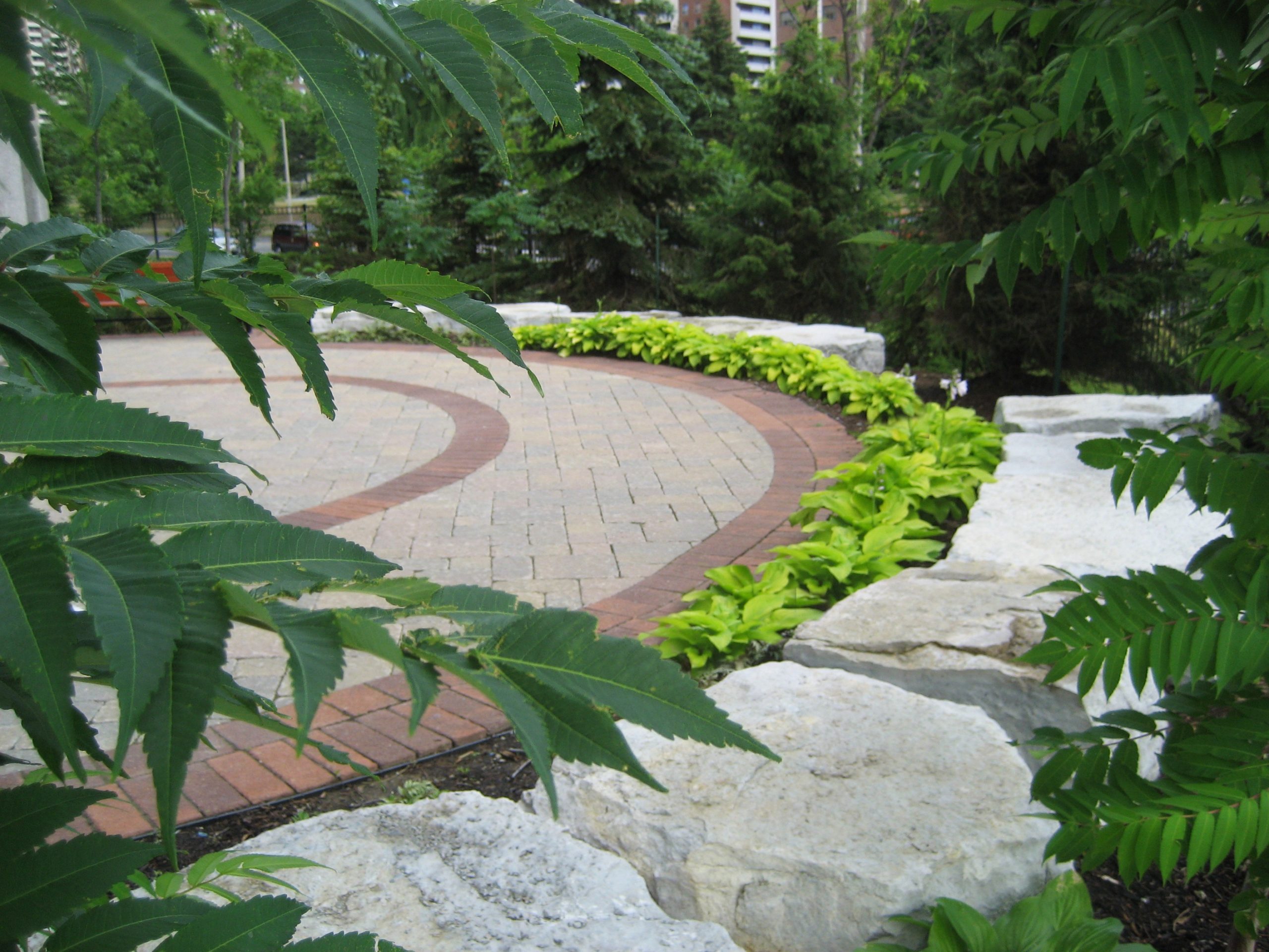 Curved pathway with large rocks along the edge