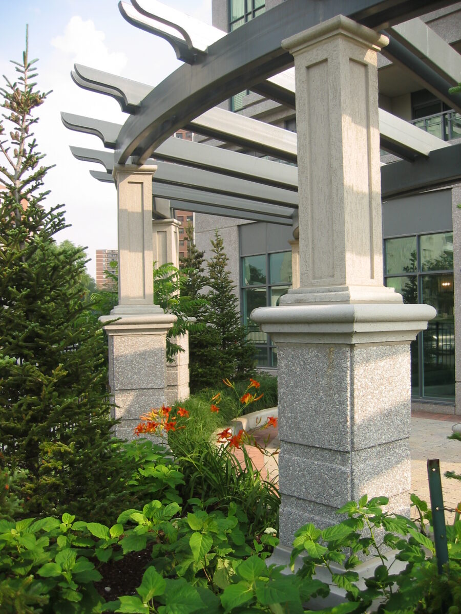 Monolithic, meandering garden trellis and seat walls defining the arrival plaza