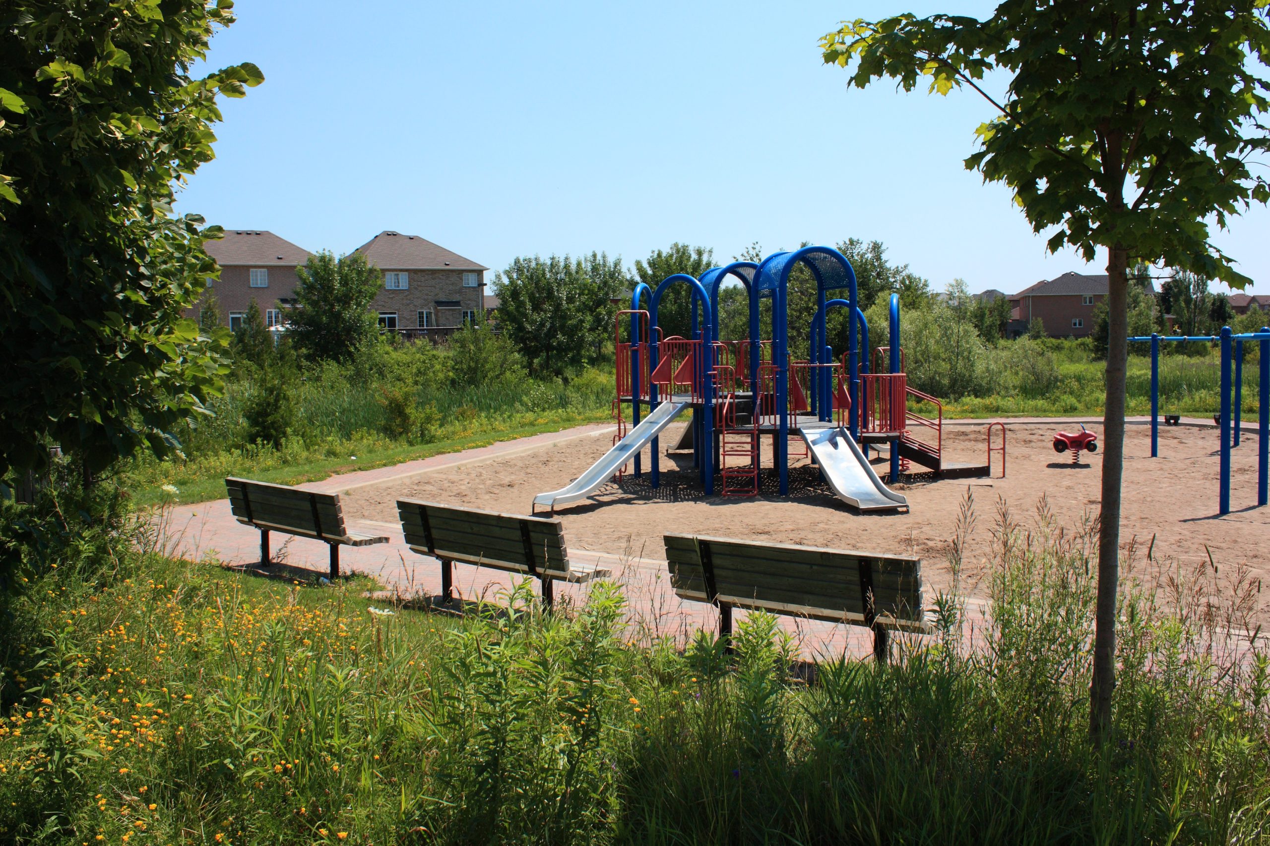 Childrens park with wooden benches along the side