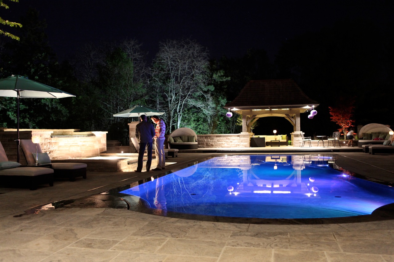 Night time shot of pool illuminated.