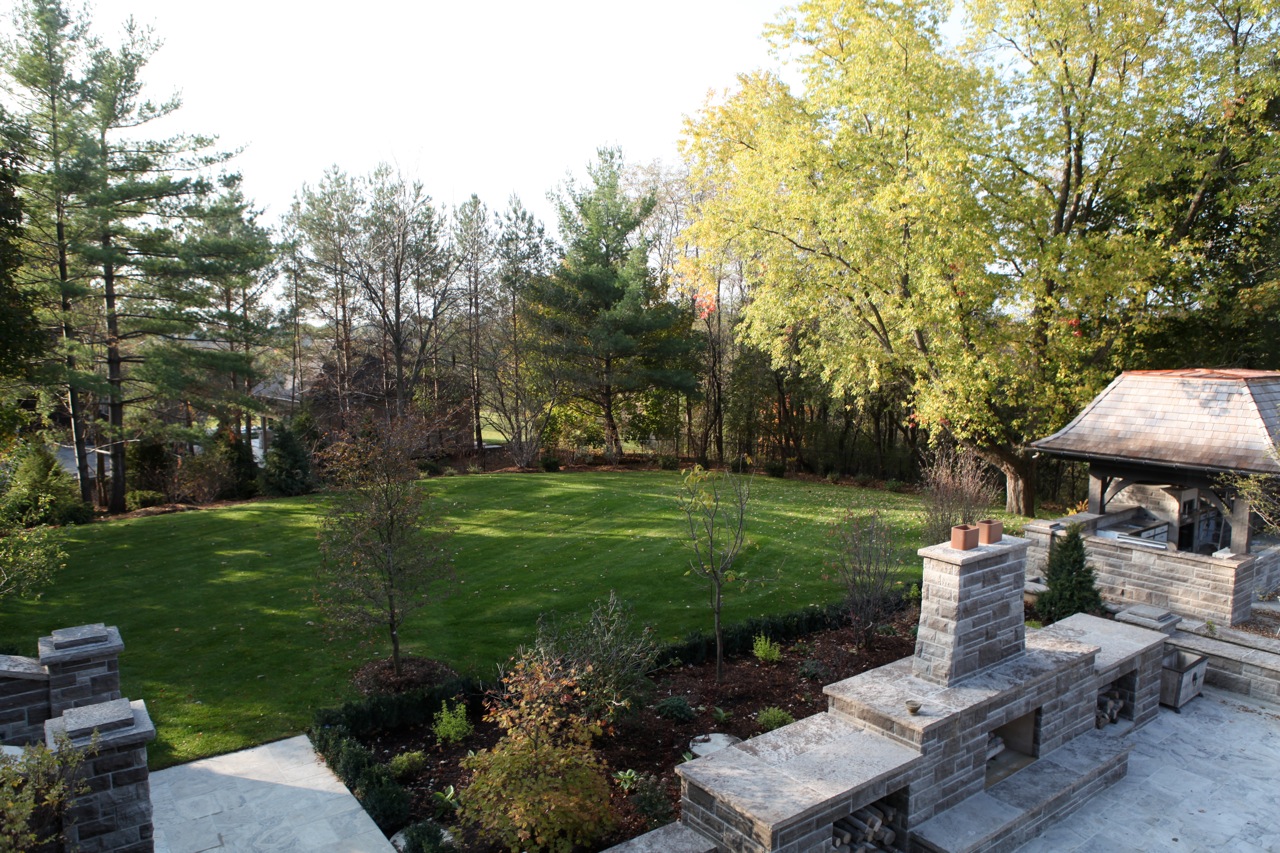 Backyard with fireplace and outdoor kitchen.