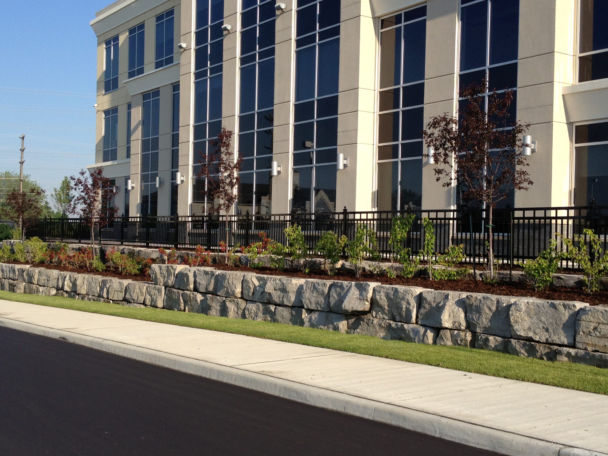 Front of building with retainer wall full of gardens