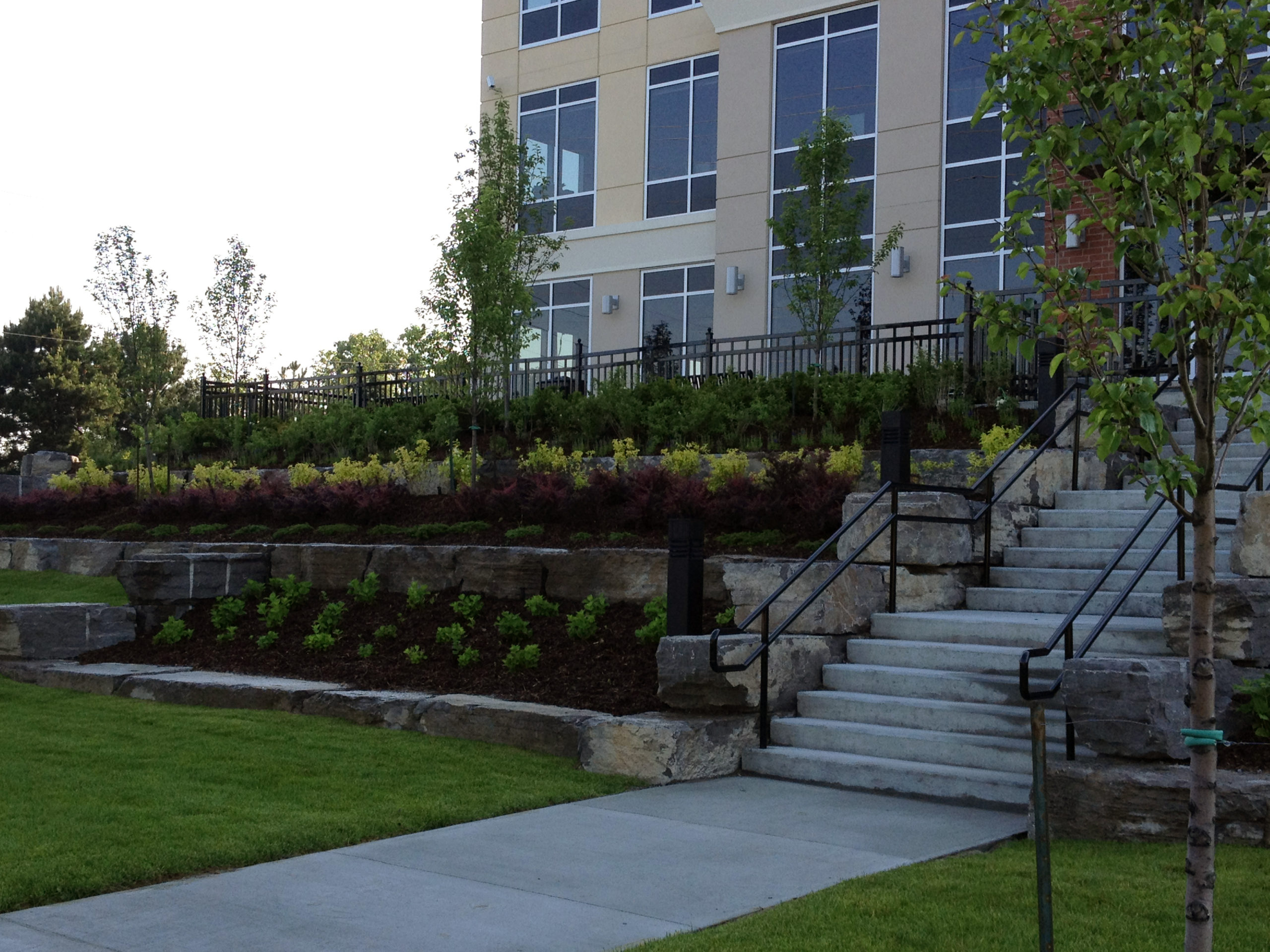 Front of building with stairs and shrubs on either side